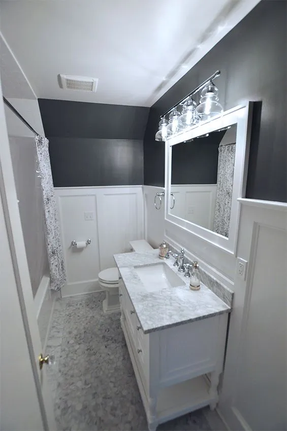 Small bathroom idea with white vanity, marble countertop, and dark accent walls, Craftworks Construction, Fairfield County CT