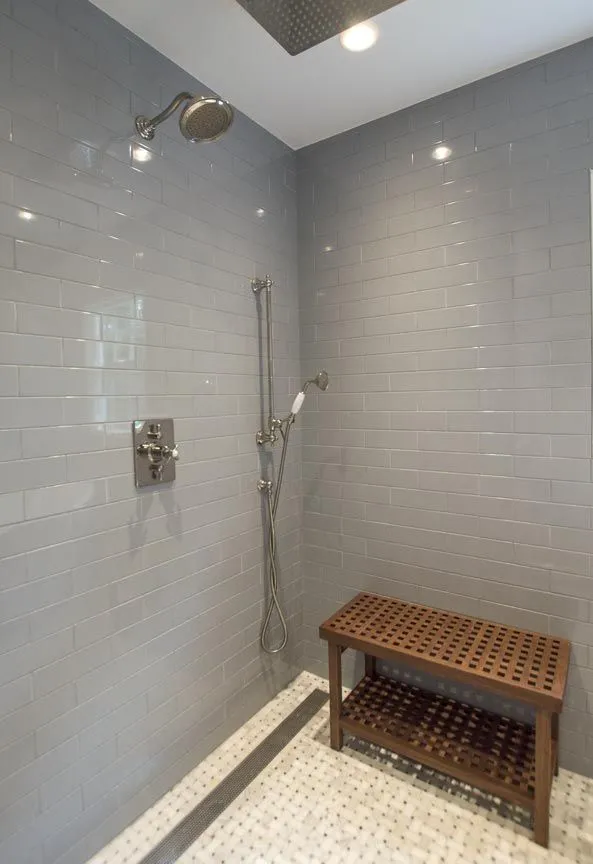 Craftworks Remodeling curbless walk-in shower with teak bench and handheld bar for accessibility, Fairfield County