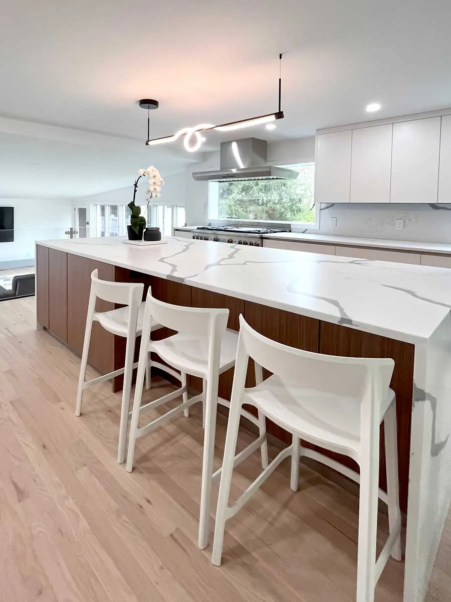 Modern kitchen remodel with wood island and bar stool seating in Fairfield County, CT