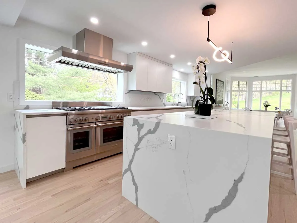 Modern kitchen remodel with waterfall quartz island and stainless steel range, Craftworks Construction, Fairfield County CT