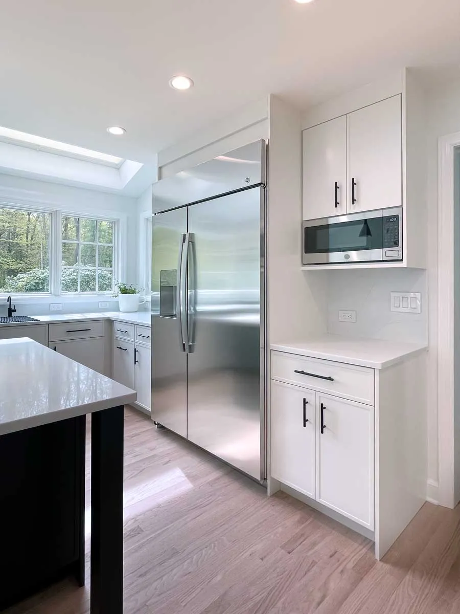Kitchen remodel with stainless refrigerator and white cabinets in Fairfield County, CT