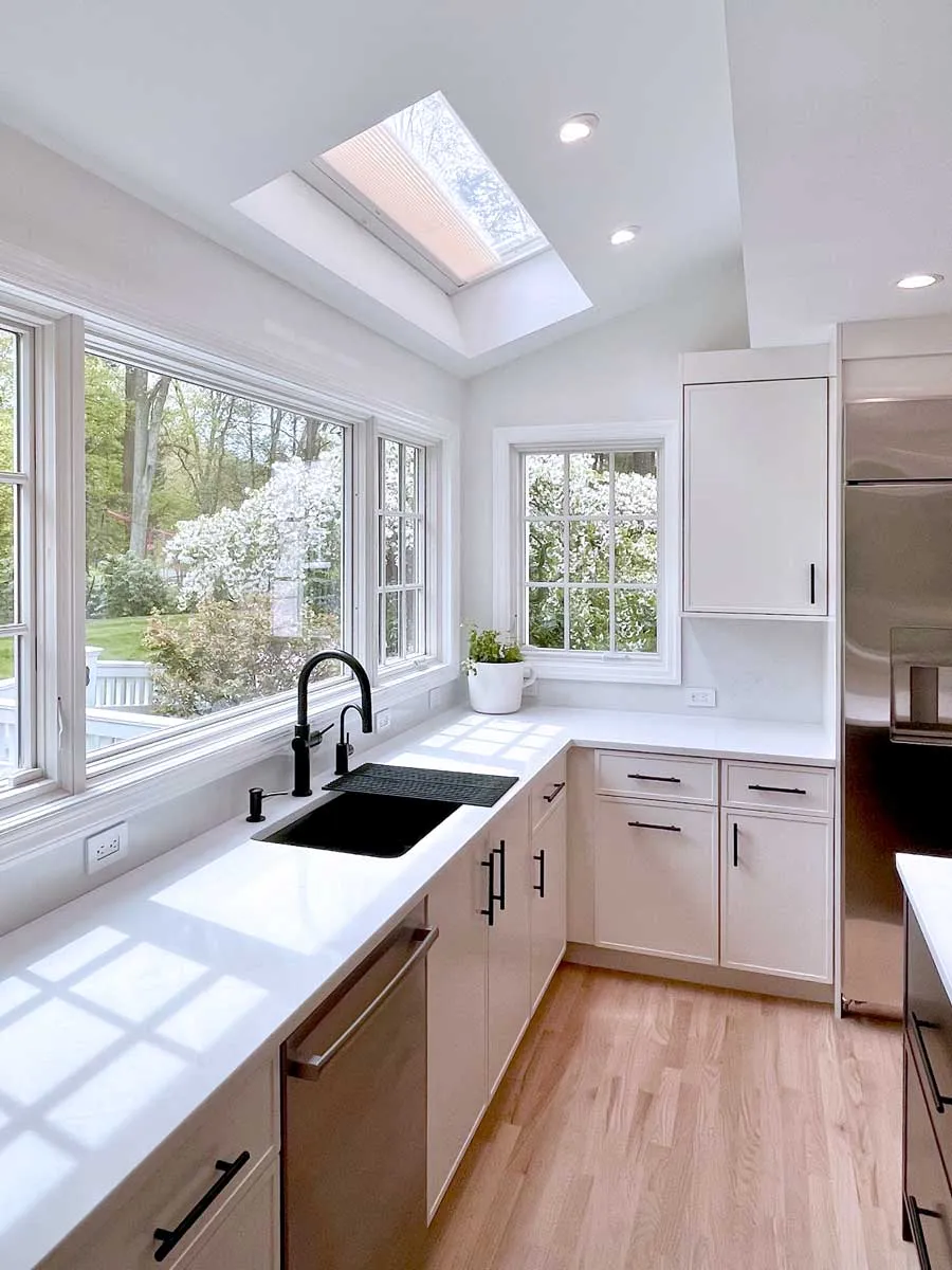 Custom kitchen remodel with black sink fixtures and natural light in Fairfield County, CT