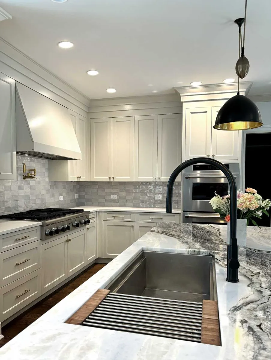 Kitchen remodel with workstation sink and black faucet in Fairfield County, CT