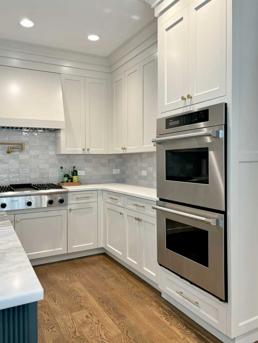 Custom kitchen renovation with white cabinets and stainless double oven in Fairfield County, CT