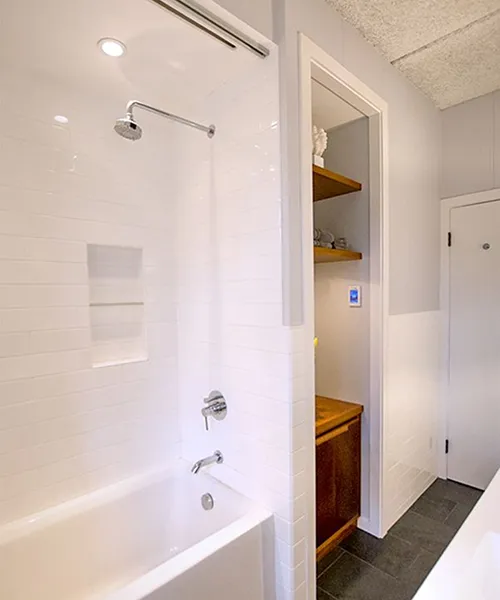 Fairfield County bathroom renovation with tiled shower, soaking tub, and built-in shelving by Craftworks Construction
