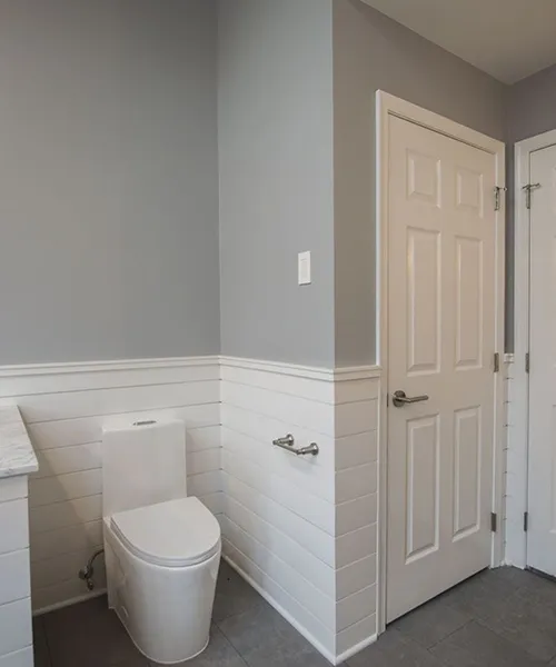 Modern bathroom remodel with two-tone walls and chrome towel bar, Craftworks Construction