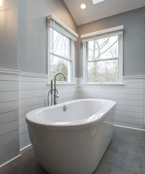 Fairfield County bathroom renovation featuring oval soaking tub, floor-mount faucet, and shiplap accent walls by Craftworks Construction