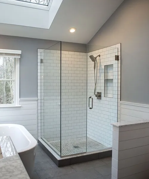 Frameless glass corner shower with white subway tile and skylight, Craftworks Construction, Fairfield County CT
