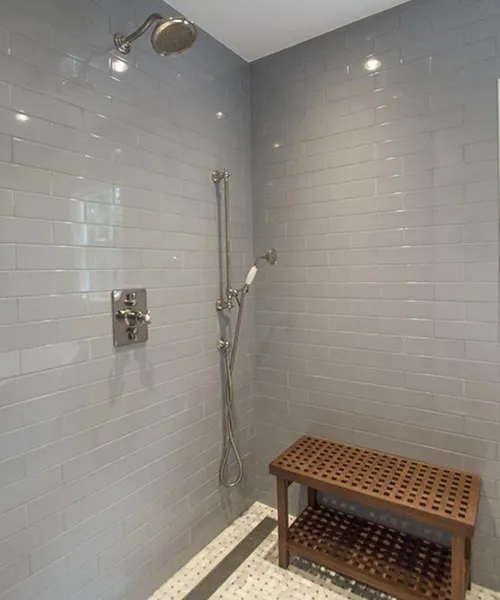 Walk-in shower with handheld bar for accessibility, gray subway tile, Craftworks Construction bathroom remodel