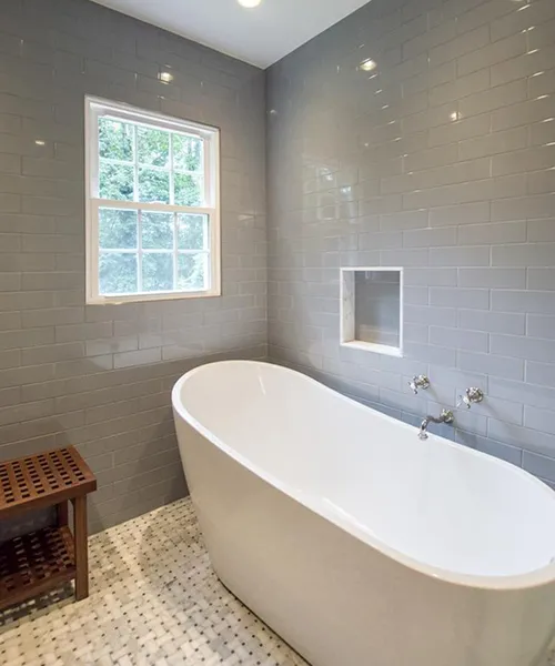 Bathroom remodel by Craftworks Construction featuring white subway tile shower and tub, Fairfield County CT