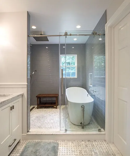 Frameless glass shower and freestanding tub in bathroom remodel by Craftworks Construction, Fairfield County CT